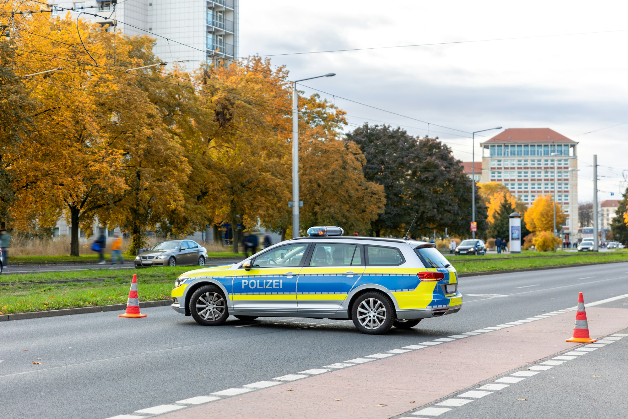 German Police car blocks road traffic at Dresden city street for safety reasons at demonstration